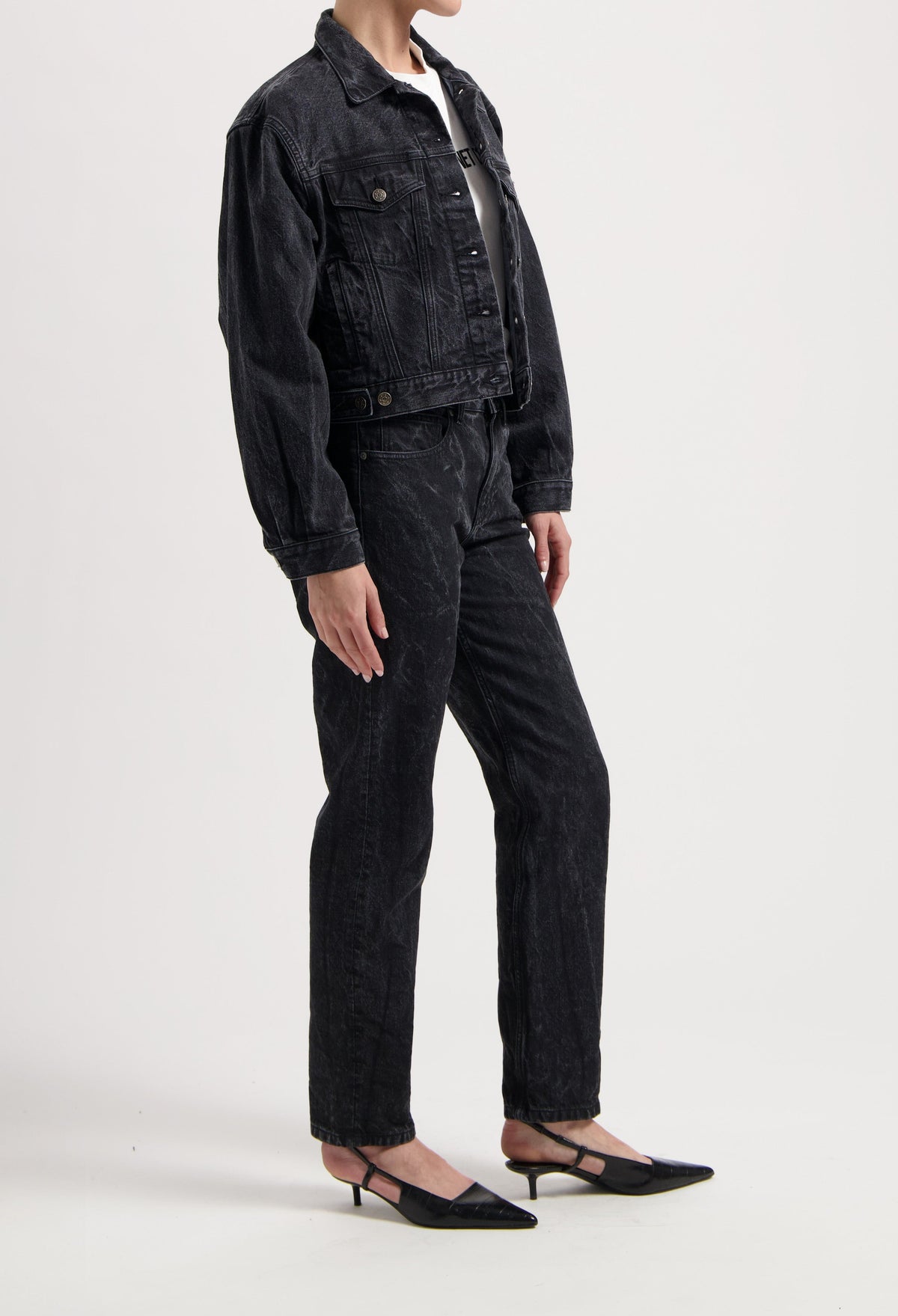 Black denim jacket and jeans set with a classic fit, paired with a white top and black pointed-toe kitten heels.
