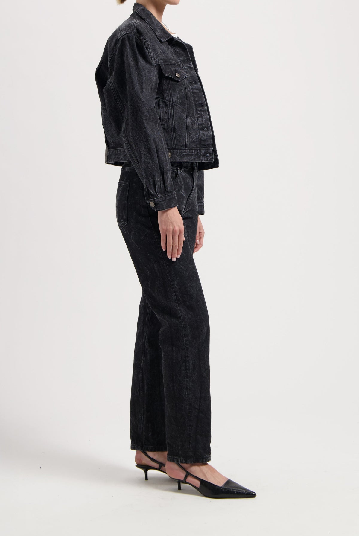 Dark wash denim jacket and wide-leg jeans ensemble paired with black pointed-toe heels, showcasing a chic casual outfit.