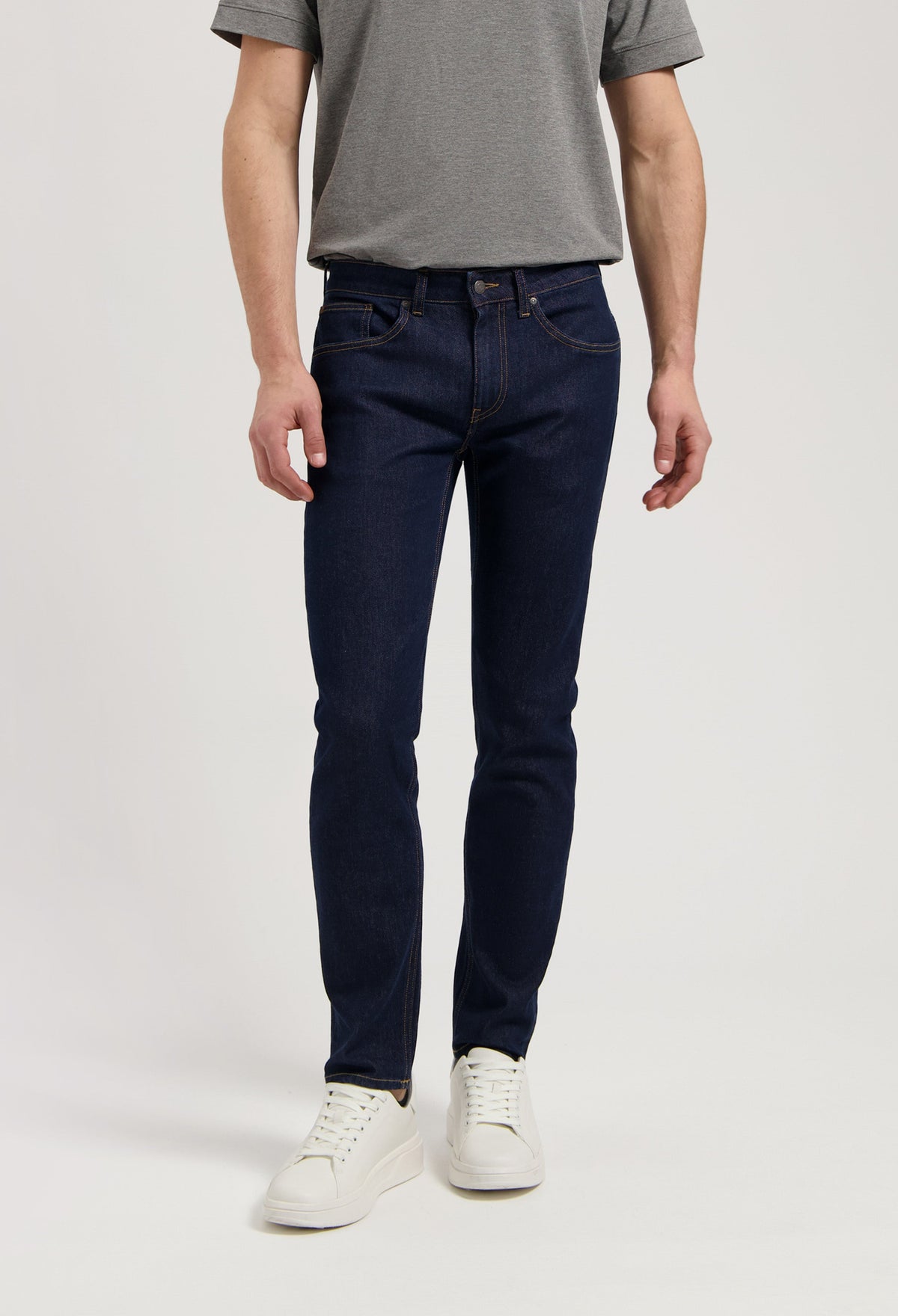 Sustainable MUD Jeans in black denim paired with a cozy gray sweater, showcasing ethical and eco-friendly fashion.