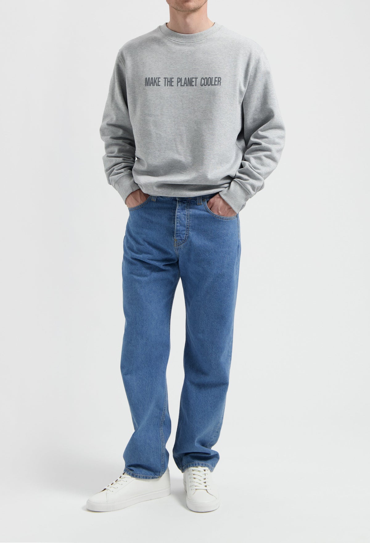 Sustainable MUD Jeans in classic blue denim, paired with a gray eco-friendly sweatshirt, embodying ethical fashion.
