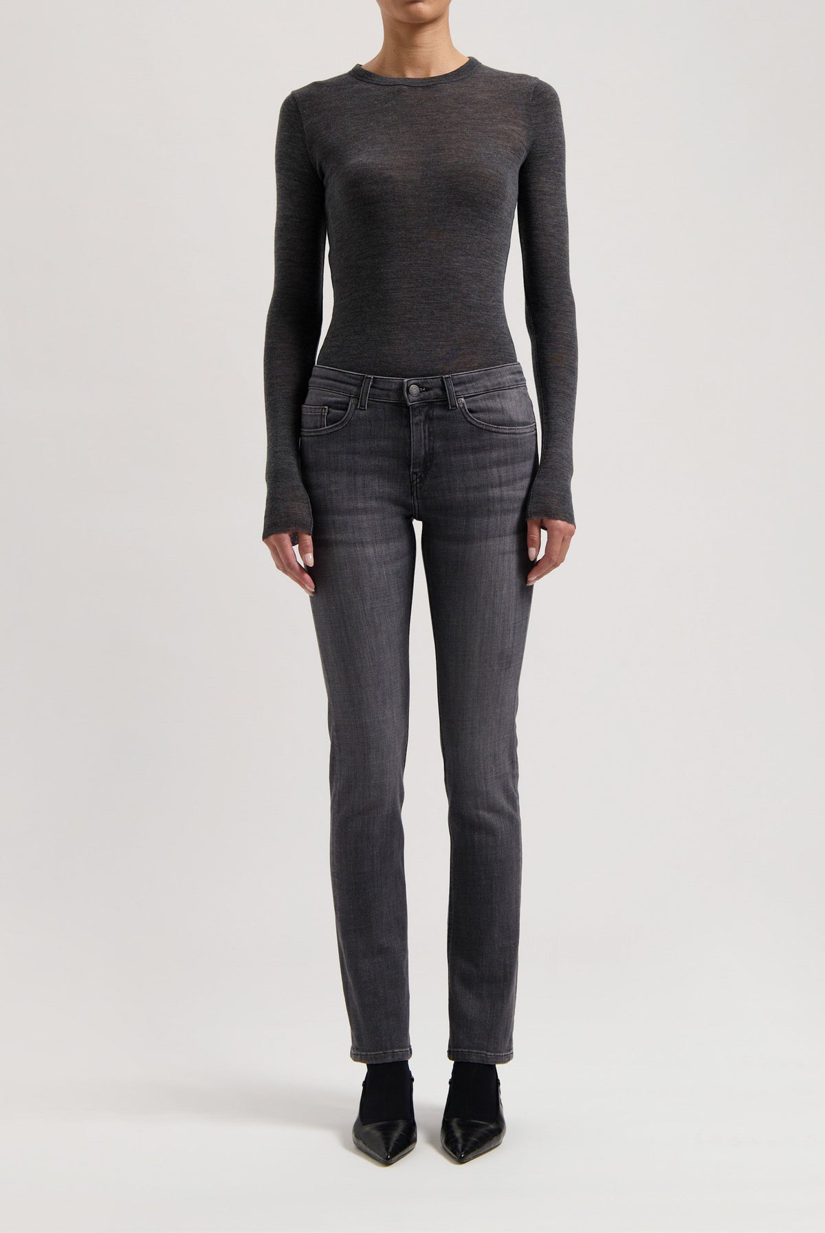 A sleek dark gray long-sleeve top paired with charcoal slim-fit jeans, highlighting a minimalist, modern fashion look.