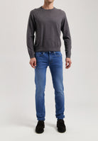 Sustainable MUD Jeans in classic blue denim, made from organic cotton, showcasing ethical fashion and eco-friendly craftsmanship.